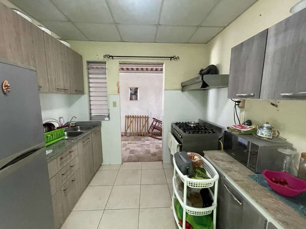 Single home with garden, tile roof, carport, fenced yard at Colinas del Lago Las Cumbres Panama