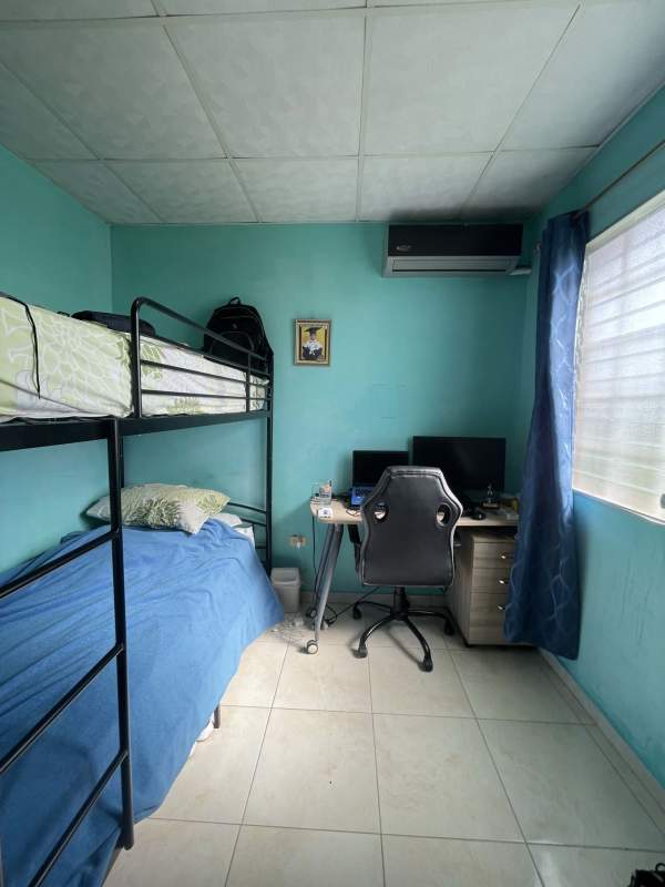 Bedroom with turquoise wall bunk bed study area at Colinas del Lago Las Cumbres Panama