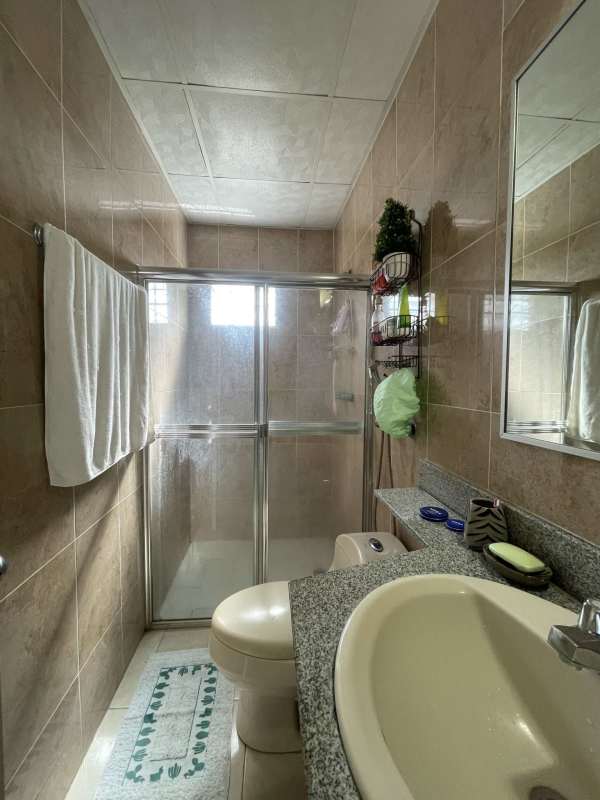 Bathroom with glass shower granite countertop vanity at Colinas del Lago Panama