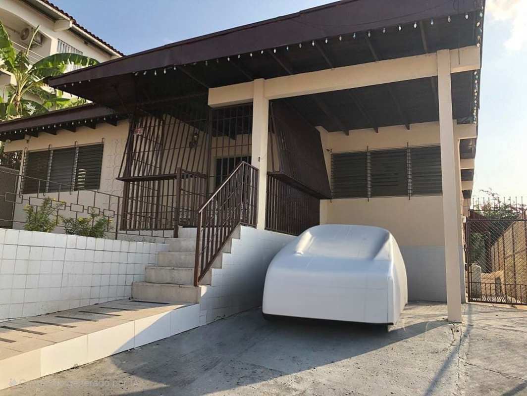 Traditional living room with tile floors, large windows, exposed beams in El Dorado Panama