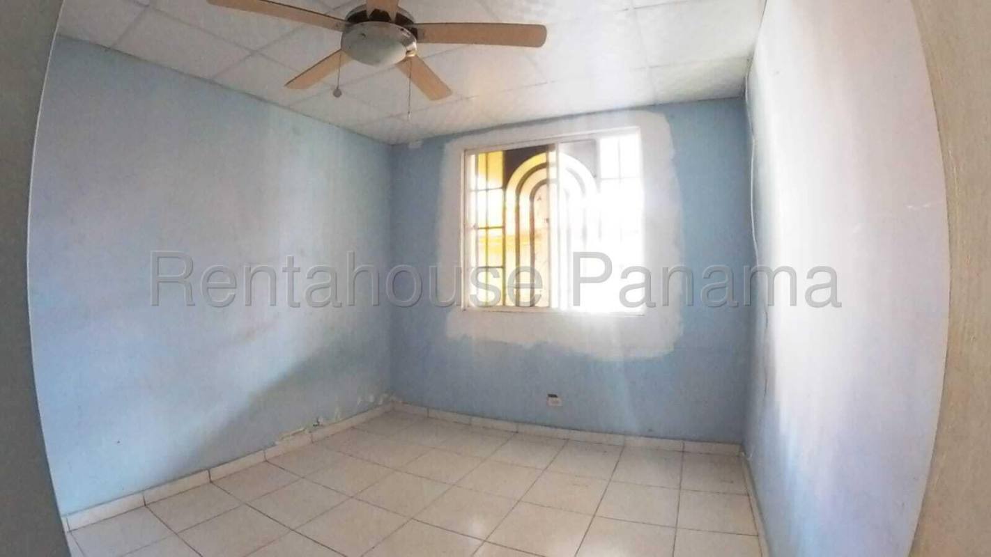 Unfinished kitchen with tiled walls, window, and access door in Panama house for sale