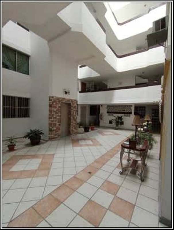 Spacious central atrium with tiled floors and planters at PH Campo Limberg Panama City