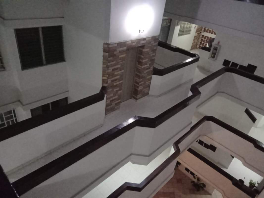 Multi-level corridor with accent stone wall inside PH Campo Limberg apartment building