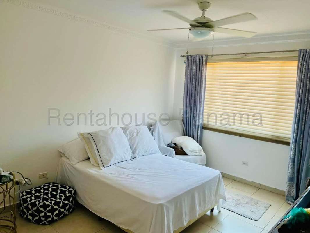 Outdoor covered terrace with ceiling fan and stone accent wall Villa Tivoli Brisas del Golf