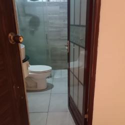 Interior hallway with arch, chandelier lighting, mosaic tile floor in Alto de San Judas house Colón
