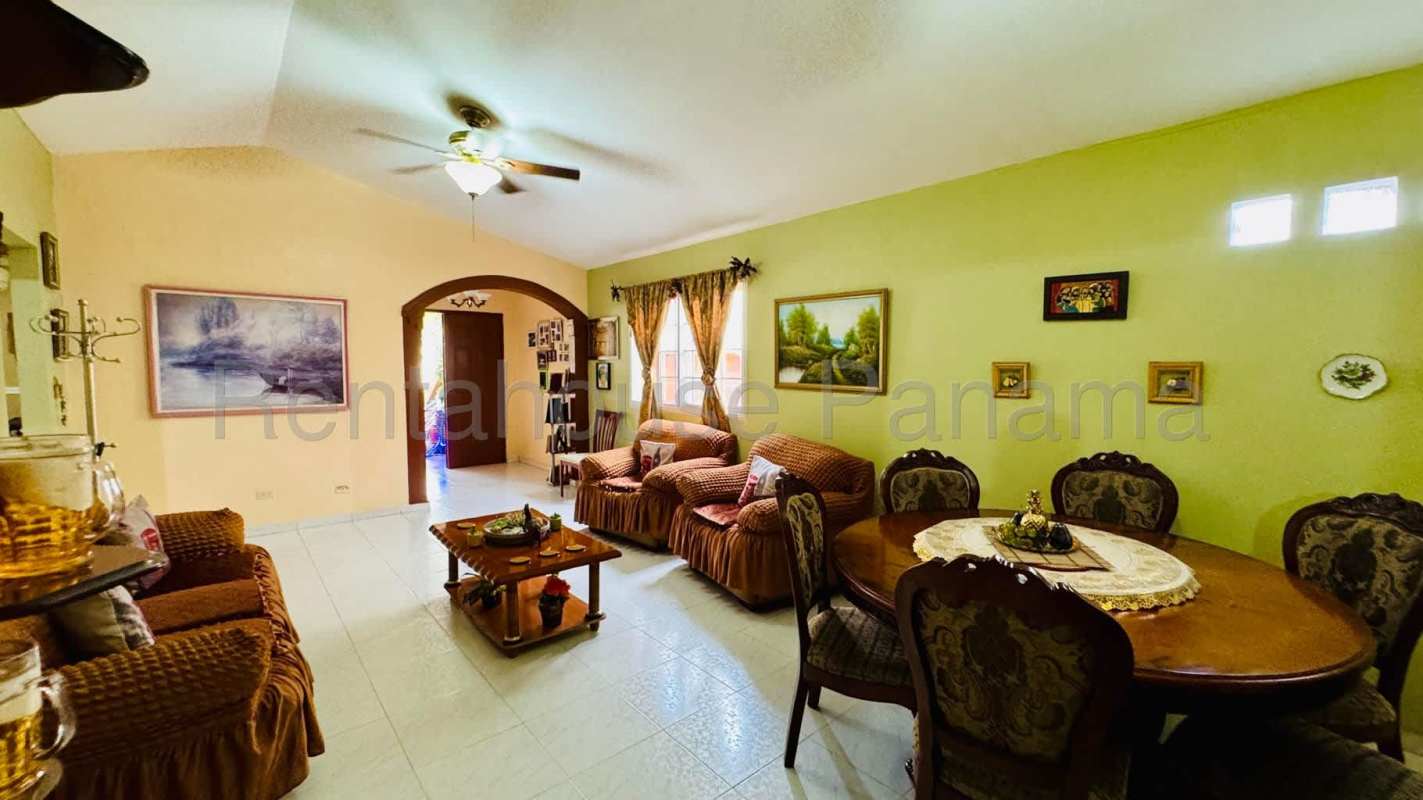 Spacious living and dining room with ceiling fan, tile floor, arched doorway in Brisas del Golf Panama
