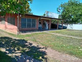 Roadside view with fencing and adjacent development land in David Chiriquí Panama