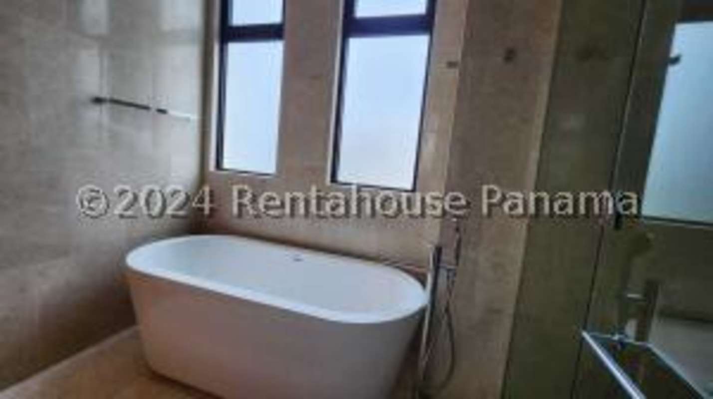 Master bedroom with floor-to-ceiling windows overlooking golf course PH Santa Maria Court Panama