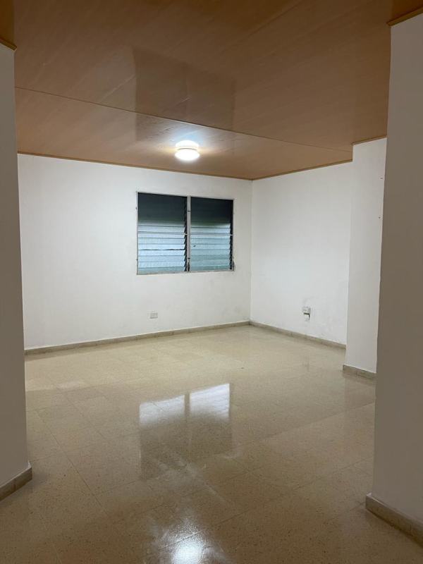 Living room with beige tile flooring, wood ceiling and louvered window in Betania apartment rental Panama City