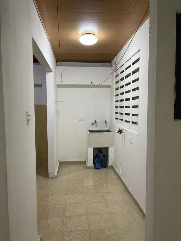 Indoor laundry area with utility sink ventilation blocks tile floor at PH Castro Betania Panama for rent