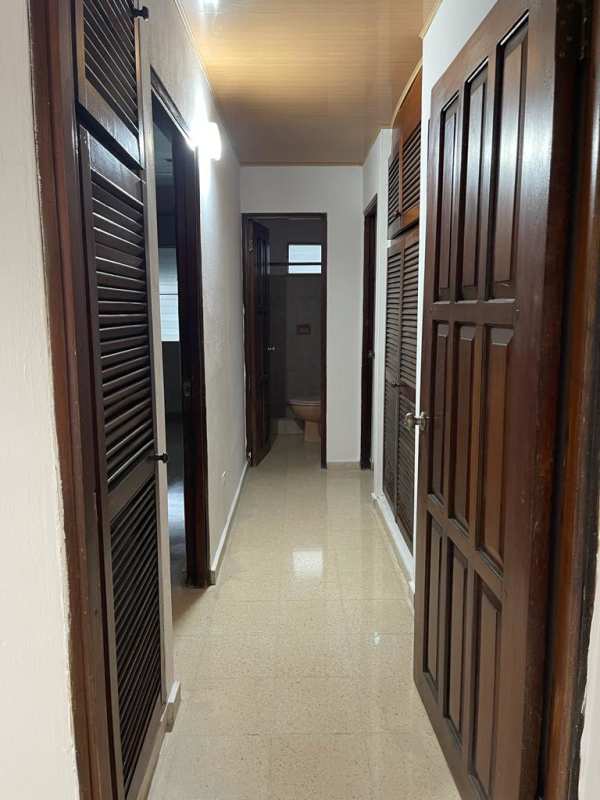 Interior hallway with polished floor wooden doors ceiling and neutral walls Betania PH Castro Panama apartment