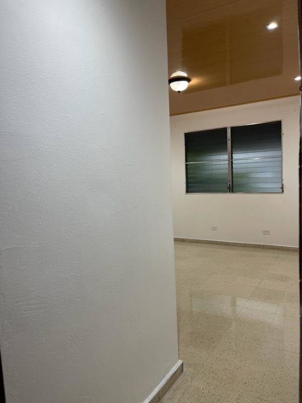 Minimalist bedroom with white walls louvered window gloss tiled floor Betania Panama apartment for rent