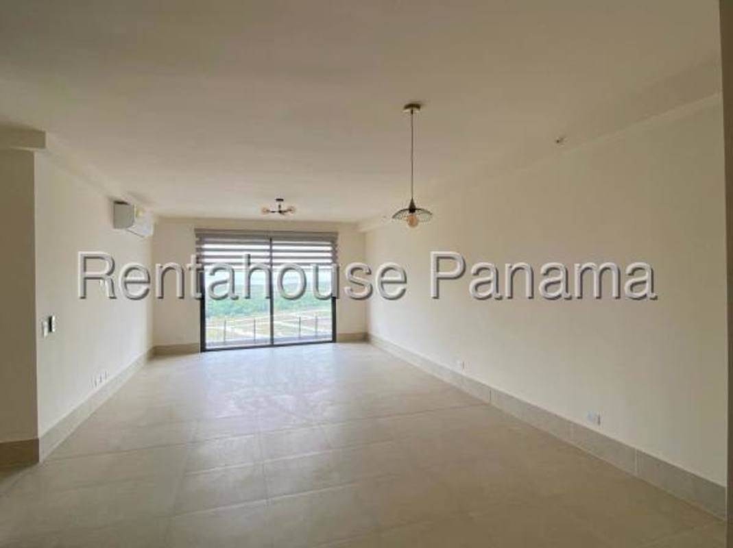 Elegant living area with large windows, ocean and golf views in Ocean House Panama City