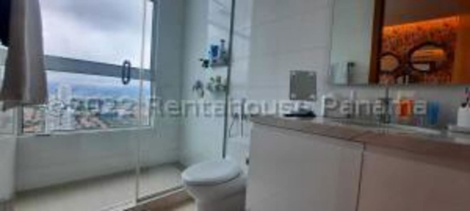 Spacious modern bathroom with glass shower and window to ocean skyline in PH Acqua Costa del Este