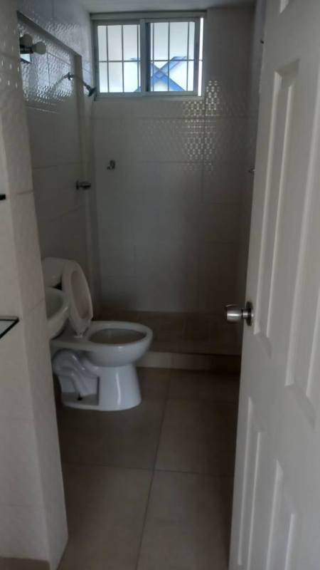 Small bathroom with tiled walls, walk-in shower and window at PH Lefevre Residences Panama City