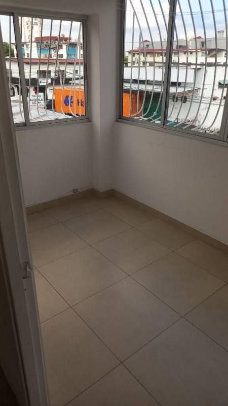 Small enclosed balcony or sunroom with barred windows in apartment PH Lefevre Residences Panama City