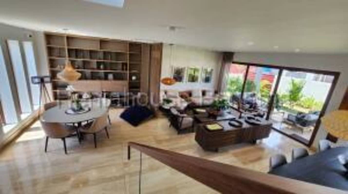 Modern dining area with large windows facing gardens at The Woods Santa Maria