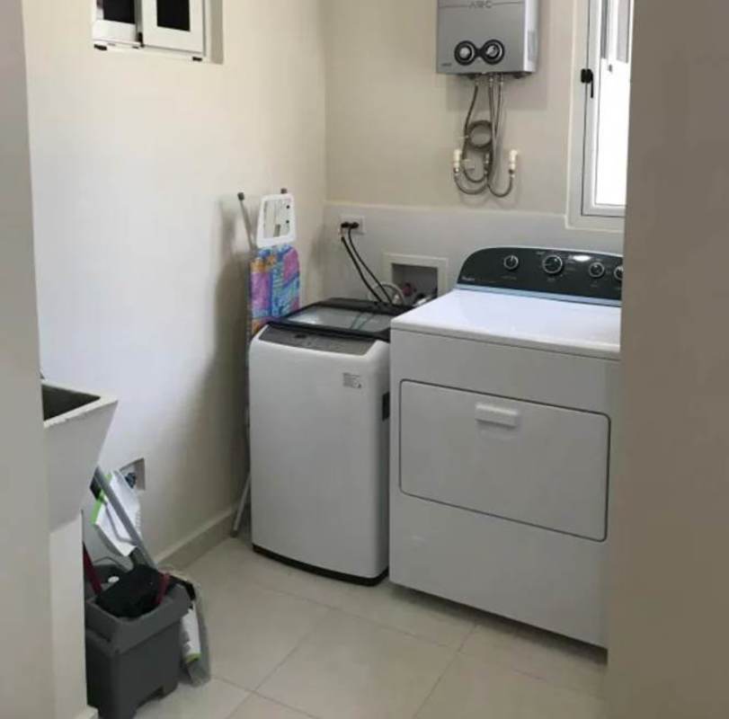 Dedicated laundry area with hookups and utility sink in Torres de Versalles Costa Sur
