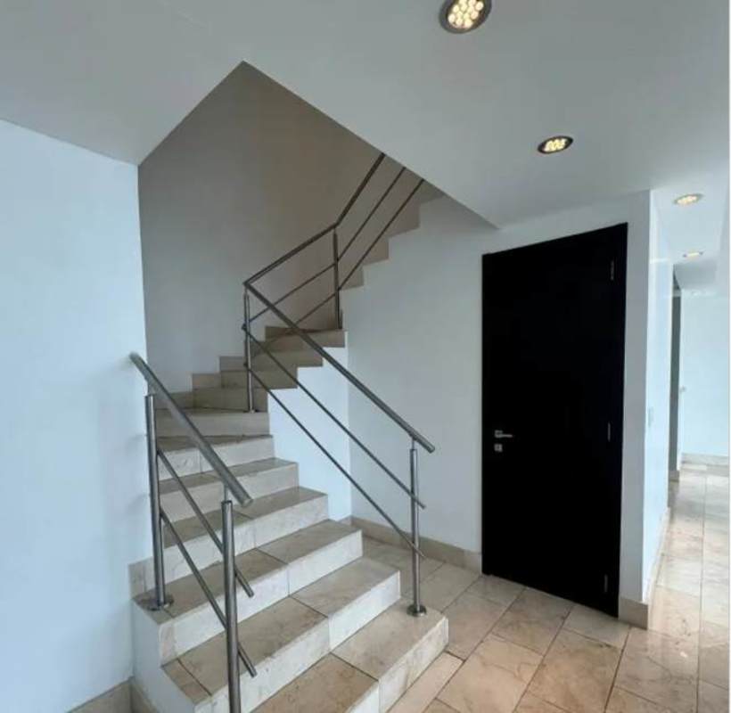 Walk-in closet with cabinetry leading to ensuite bathroom in PH Grand Tower Punta Pacífica