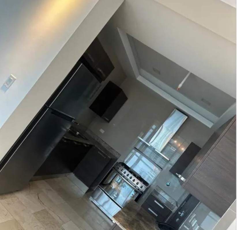 Modern kitchen with granite countertops and stainless steel appliances at PH Grand Tower Punta Pacífica