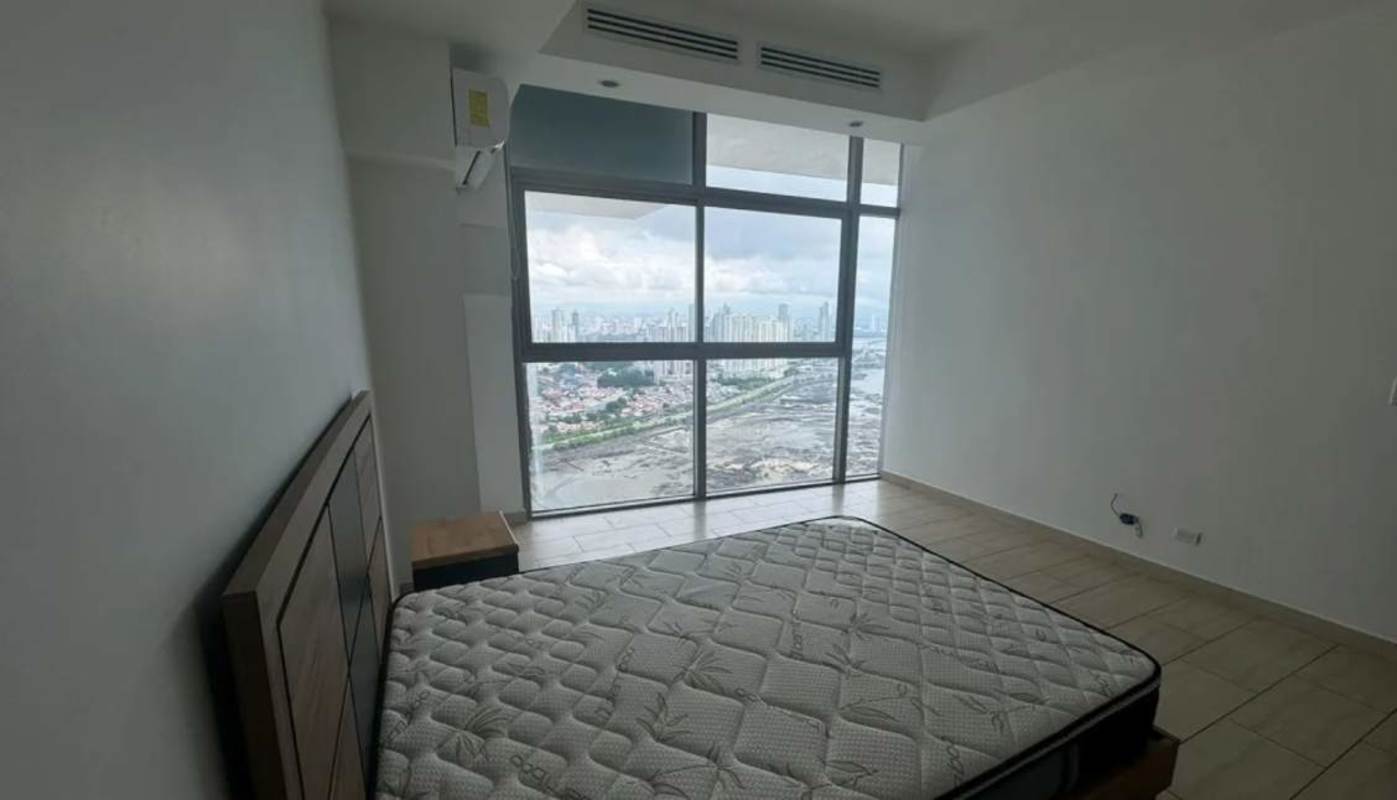 Loft-style living room with floor-to-ceiling windows offering ocean views at PH Grand Tower Panama