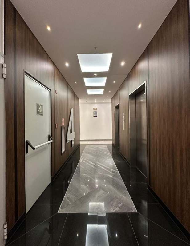 Floor hallway with number signage, wood panels, marble flooring in PH Habitáts Plaza Obarrio Panama