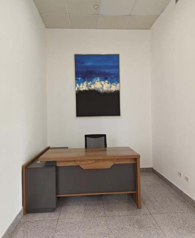 Minimalist small office with large window, skyline view, mesh chair Obarrio Panama City