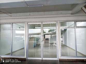 Glass door entrance and large windows in modern commercial retail unit Plaza Bugaba Chiriquí
