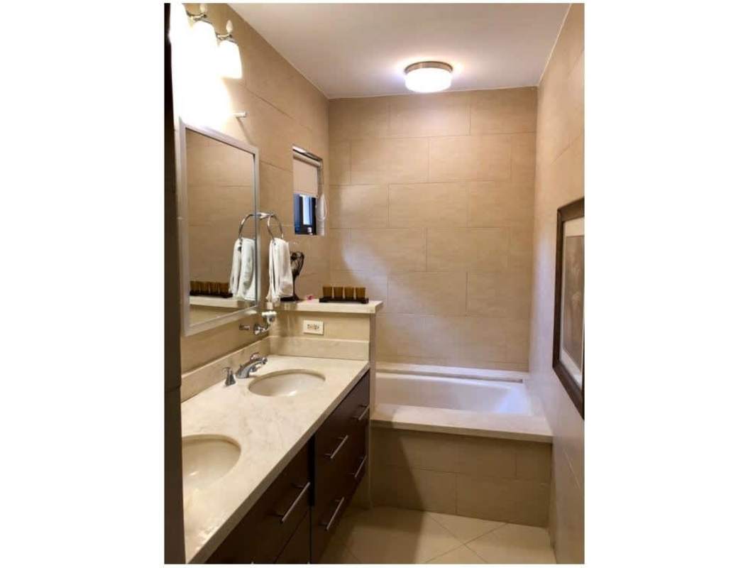 Modern bedroom with balcony access and garden view at PH Clayton Park Clayton Panama