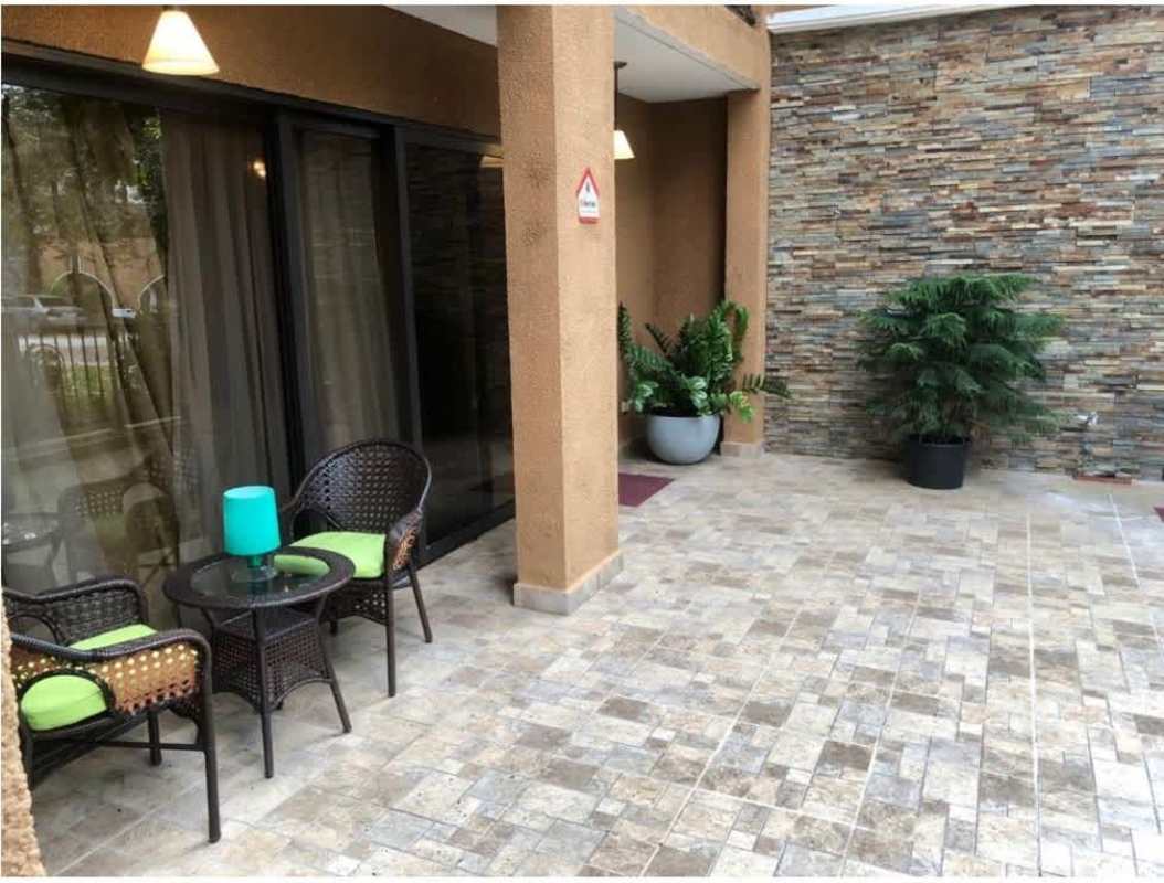 Laundry room with stacked washer dryer and granite countertop in PH Clayton Park Clayton Panama
