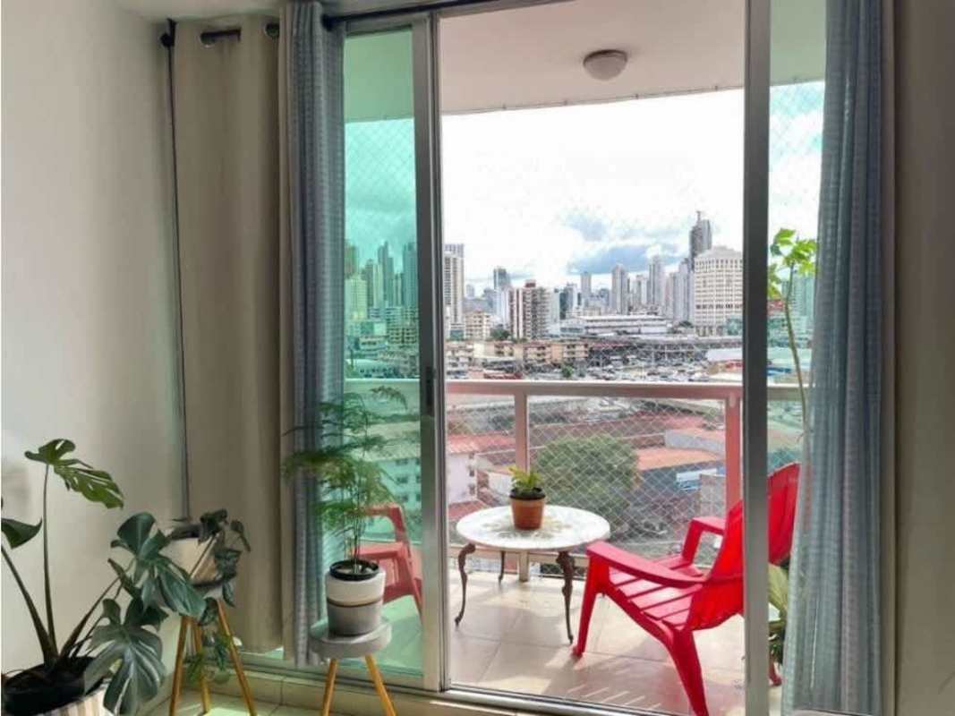Living room with sliding glass doors leading to balcony, city skyline view in PH Portofino Panama