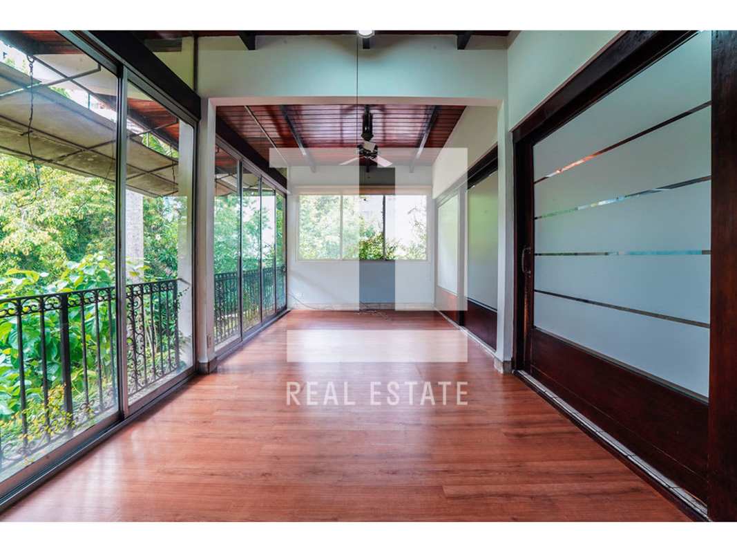 Spacious dining or conference room with wooden ceiling, large sliding doors, garden view on Via Porras Panama