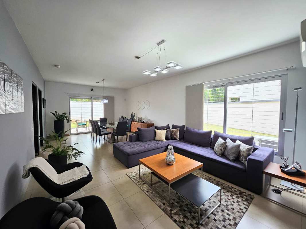 Living and dining open plan with large tile floors and ample natural light in Condado del Rey home