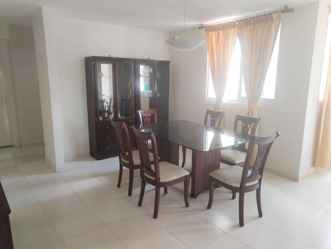 Bright dining room with large windows, glass dining table and cabinet PH Aurora Tower Panama