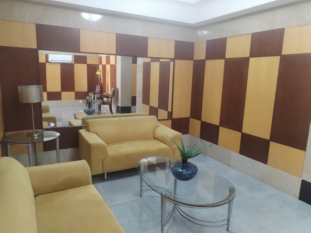 Building lobby lounge with colorful sofas and geometric wall PH Aurora Tower Panama City