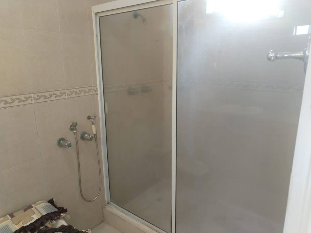 Bathroom with enclosed glass shower and granite counter in PH Aurora Tower Panama