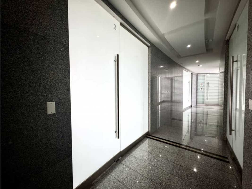 Sleek commercial hallway glass doors granite floor Golden Point Tower Panama