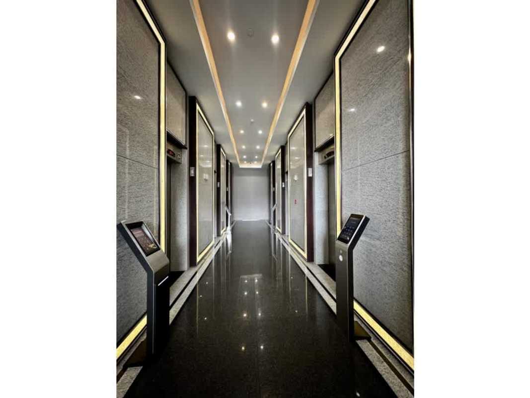 Contemporary elevator bank touchscreens black tile PH Golden Point Tower Panama