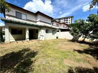 White two-story house with fenced yard for rent Palmia Woodlands Panama Pacifico