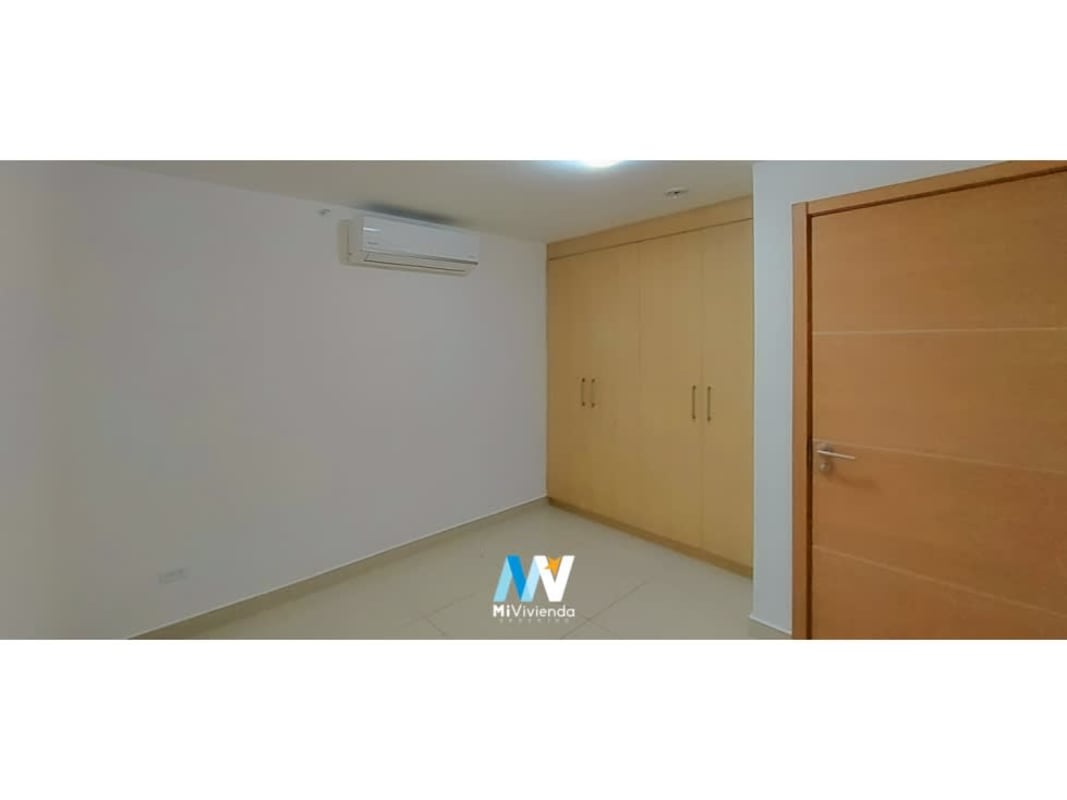 Bright bedroom with built-in wardrobe and AC unit in rental apartment Torres de Castilla