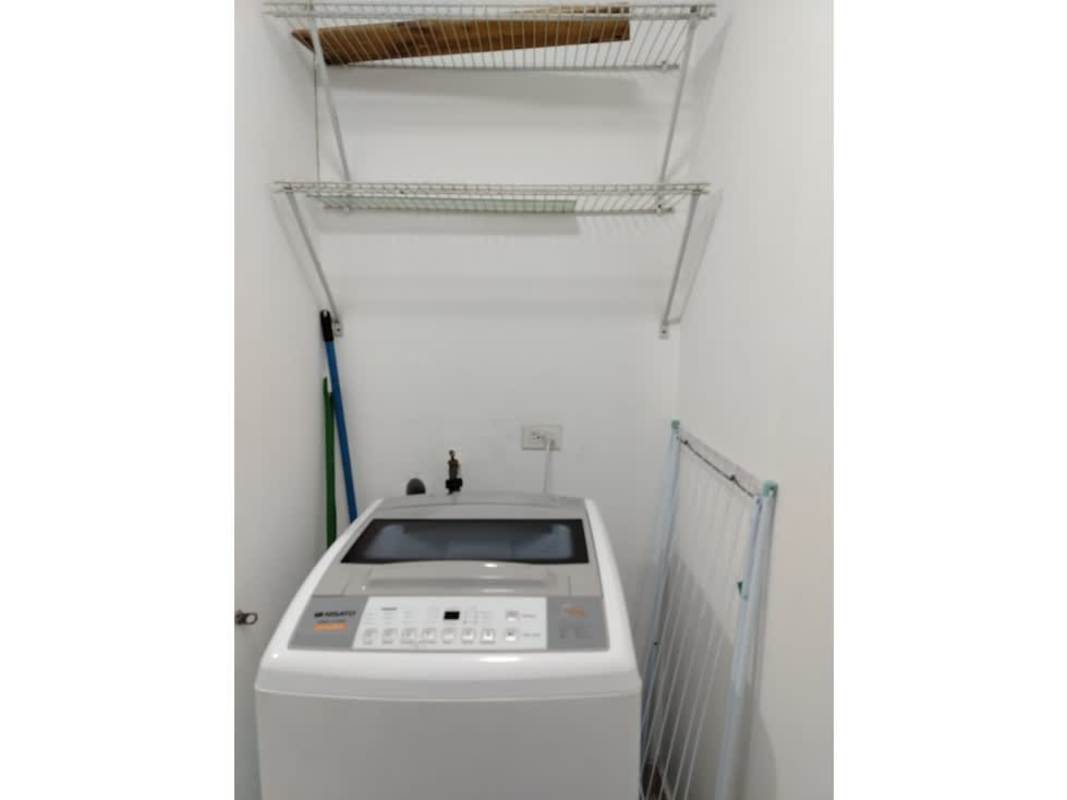 Laundry space with washer and shelves PH Mystic Tower Rio Abajo Panama
