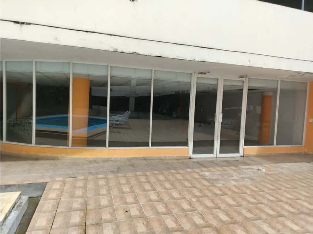 Modern glass building with visible indoor swimming pool PH Mystic Tower Panama