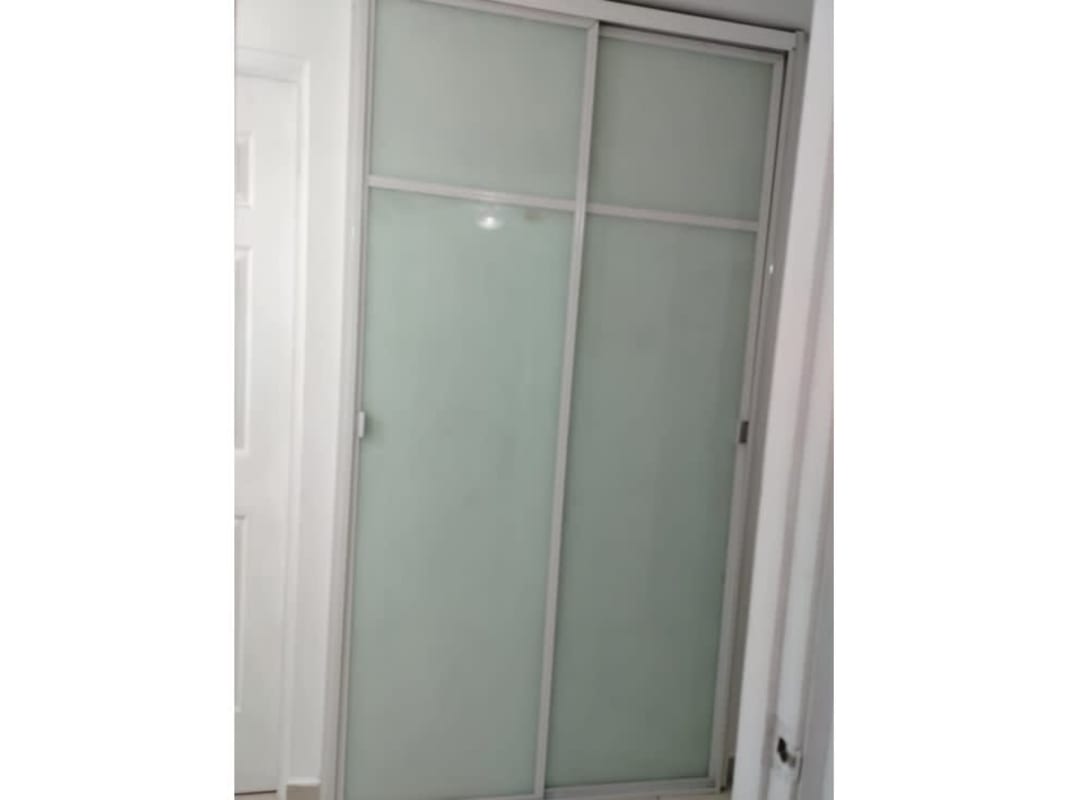 Bedroom closet with frosted sliding doors at PH Mystic Tower Río Abajo Panama