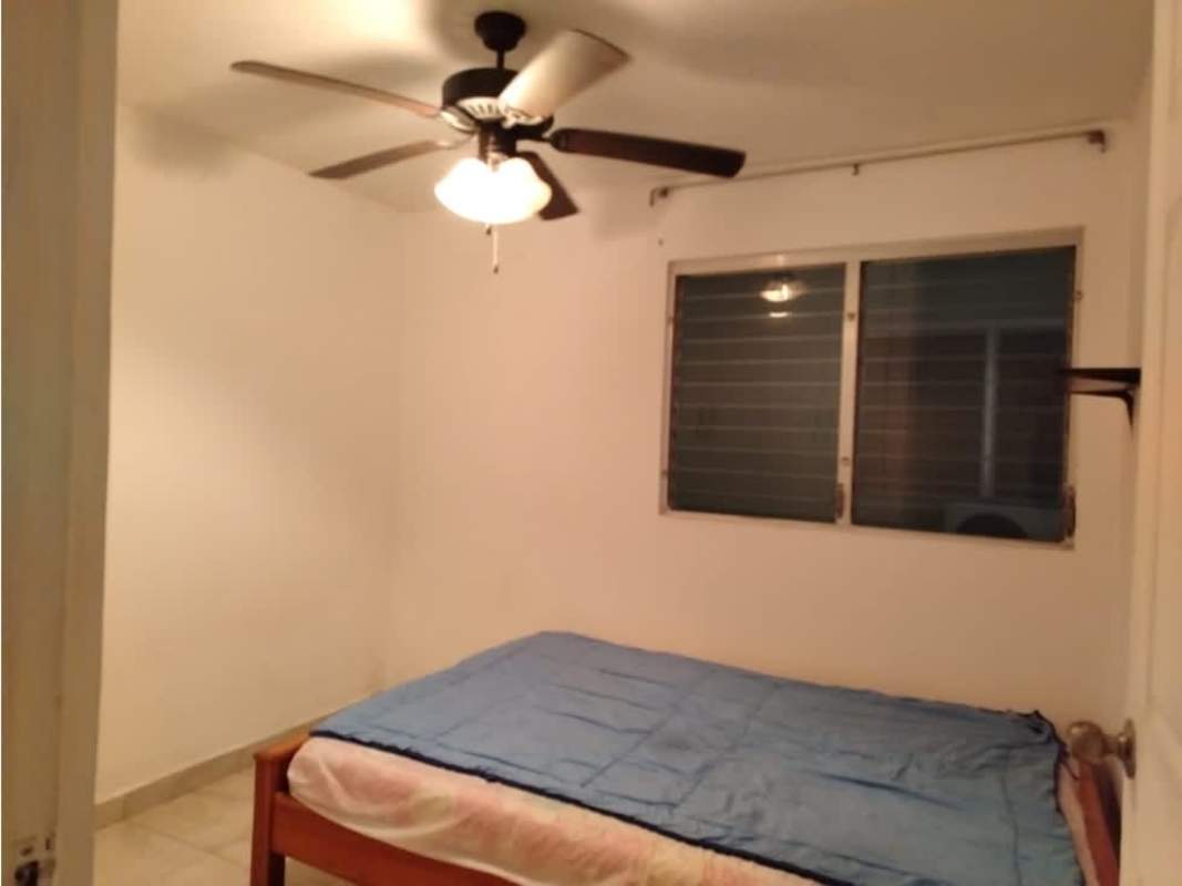 Bedroom with ceiling fan, closet, city view window at PH Mystic Tower Río Abajo Panama City