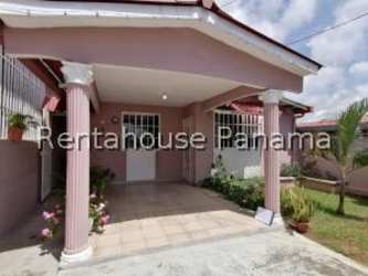 Front exterior view porch with columns small garden pink single story La Chorrera
