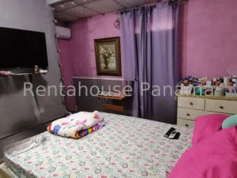 Kitchen interior featuring gas stove, dark cabinetry, refrigerator, curtained doorway Lomas de Mastranto