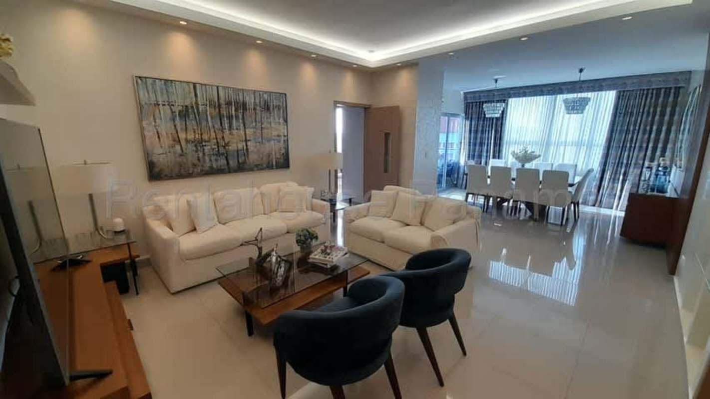 Modern furnished living and dining room with large windows in San Francisco PH South Coast penthouse Panama