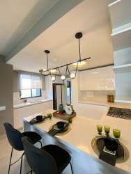 Open plan living area in modern duplex with large windows at Panama Pacifico