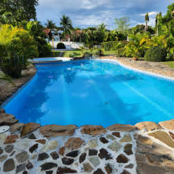 Shared swimming pool with tropical landscaping at Coronado beach rental Panama