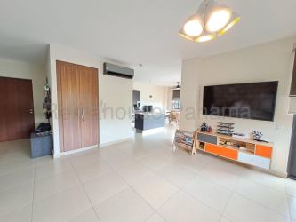 Modern living area with mounted TV, porcelain tile, ceiling fan in PH River Valley Panama Pacifico condo